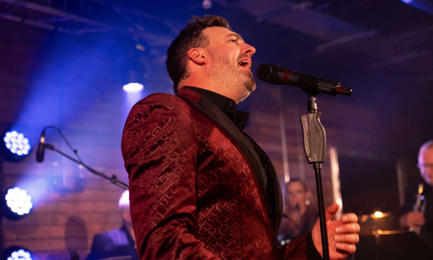 Lead singer and band performing live