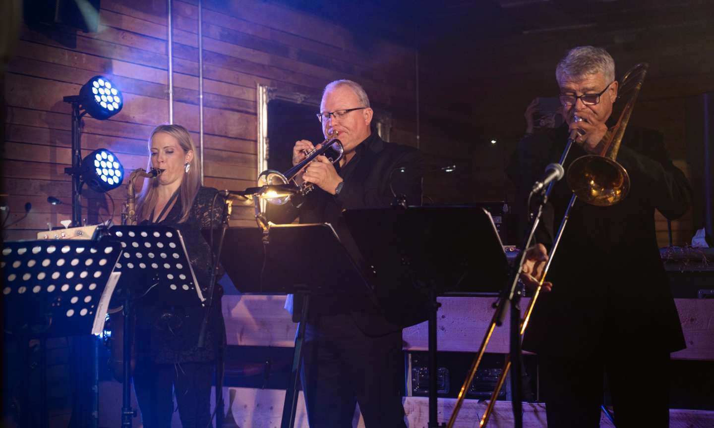 Horn section performing on stage
