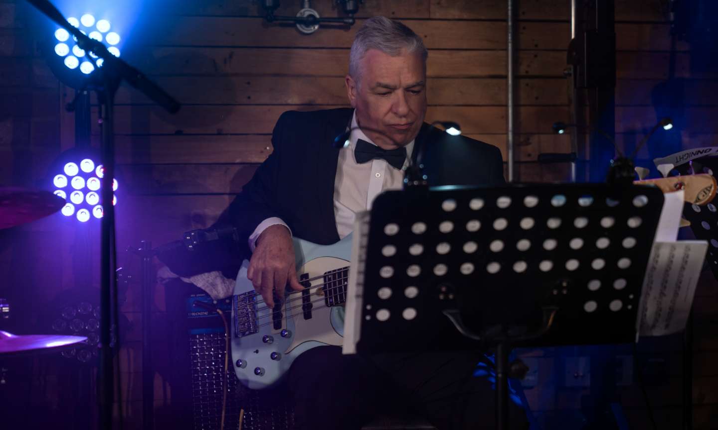 Electric Bass Guitar player performing on stage